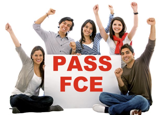 A small group of students with a plackard: Pass FCE